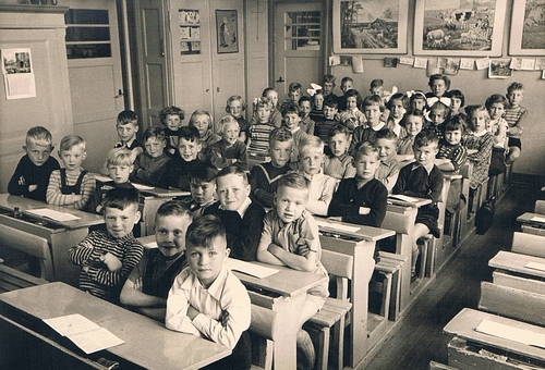 De 1e klas van juffrouw Vlegheert,1953. Frits Smit zit op de laatste rij uiterst links (met zijnhoofd voor de deurpost) Bron: Frits Smit 
